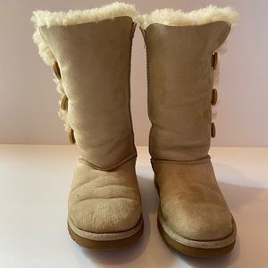 Beige Children sized Uggs with side buttons